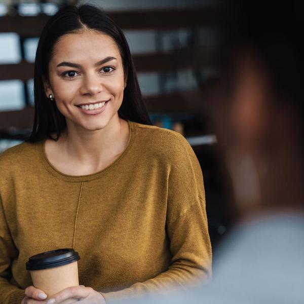 Woman with coffee in interview